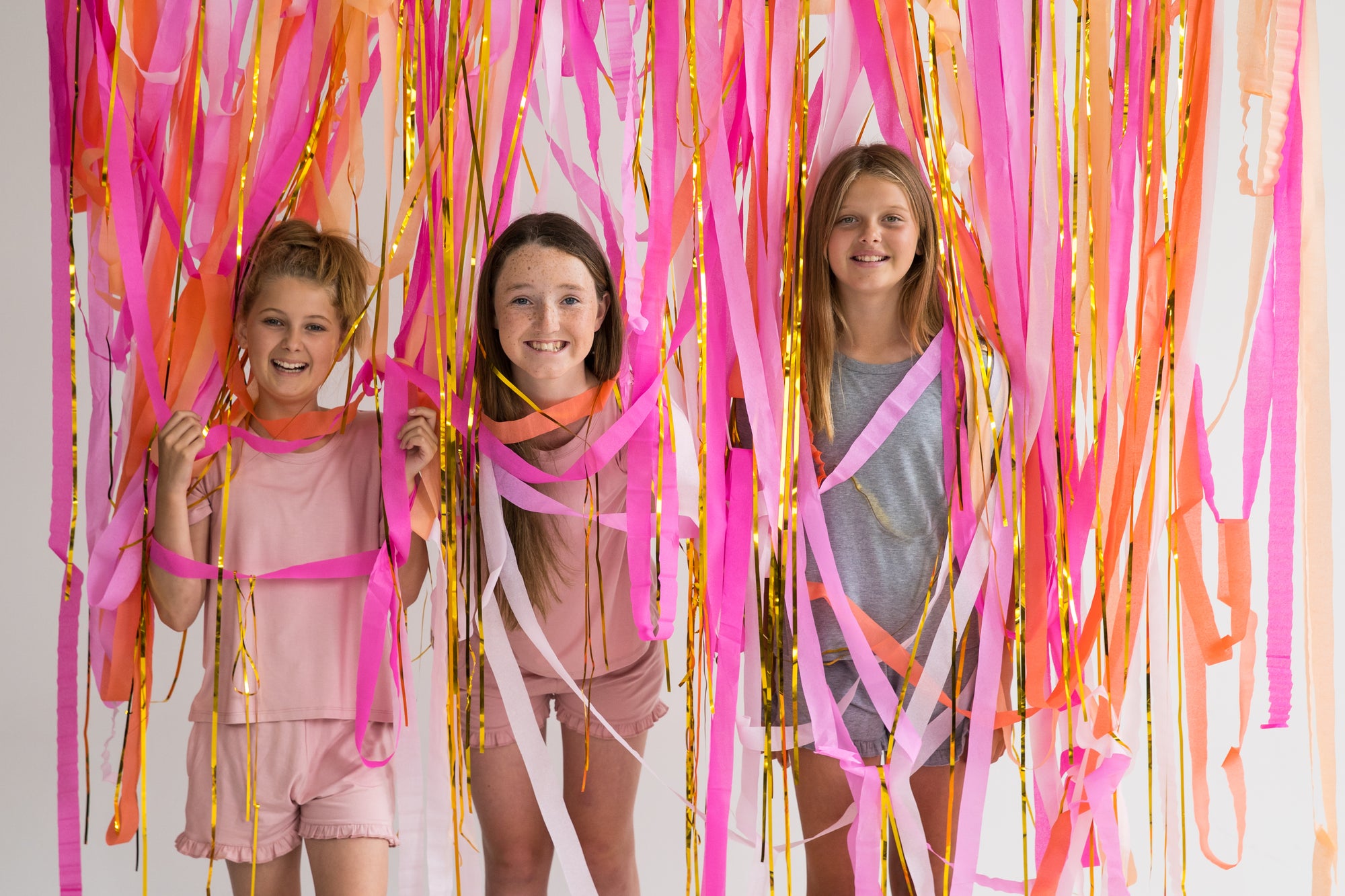 girls celebrating in front of streamers